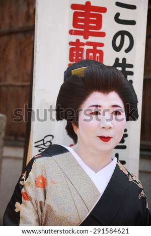 KYOTO, JAPAN - OCTOBER 14: Adult geisha is directed to a teahouse to meet their customers  on October 14, 2013 in Kyoto-Japan.