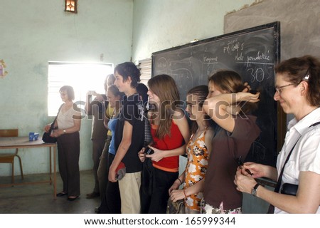 SONGRETENGA, BURKINA FASO - FEBRUARY 26: Visit of French schoolboy in Africa at the school of Songretenga. The French pupils present themselves to the pupils of Songretenga, February 26, 2007