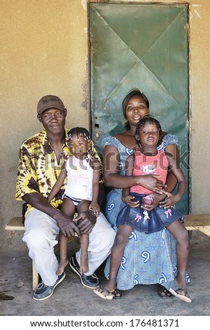 OUAGADOUGOU, BURKINA FASO - NOVEMBER 16: portrait of an African family outside his home in Ouagadougou, november 16, 2010