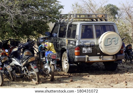 KOUPELA, BURKINA FASO - JANUARY 12: wild golden Koupela mine, the gold diggers come from everywhere to dig, the car of a French researcher gold surrounded motorcycles  African, january 12, 2008.