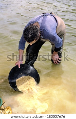 BOUCOIRAN, FRANCE - MARCH 16: Gold digger in France in the region of Cevennes and the department of Gard in the middle of the river called Le Gardon, march 16, 2014