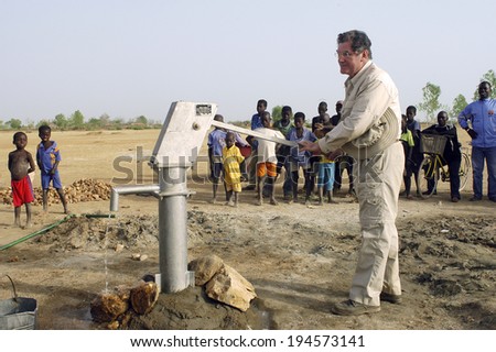 LIGUIDIMALGEM, BURKINA FASO - FEBRUARY 27: installation of a pump in Burkina Faso funded humanitarian associassion. An official of the association is happy, the water is there, February 27, 2007