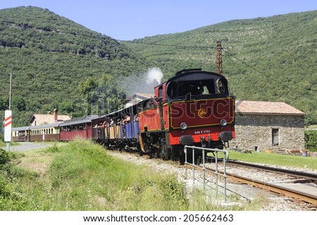 SAINT-JEAN-DU-GARD, FRANCE - JULY 15: The tourist train from Anduze returning from Saint-Jean-du-Gard and locomotive hangs upside down because there is only one way , july 15, 2014.