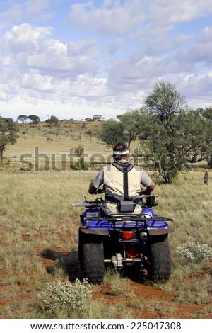 AUSTRALIA - MAY 6: Gold miner in the Australian outback starting quad explore the area with his metal detector, may 6, 2007.