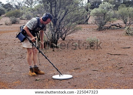 AUSTRALIA - MAY 13: Gold miner in the Australian outback prospecting area in the bush with his metal detector looking for gold nuggets, may 13, 2007.