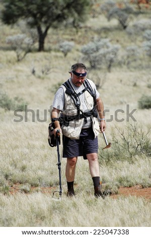 AUSTRALIA - MAY 6: Gold miner in the Australian outback prospecting area in the bush with his metal detector looking for gold nuggets, may 6, 2007.