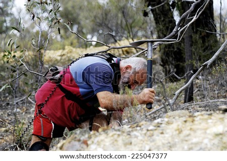 AUSTRALIA - APRIL 24: The hollow gold miner with his pick of where the detector indicated the possible presence of a nugget of gold in the ground, april 24, 2007.