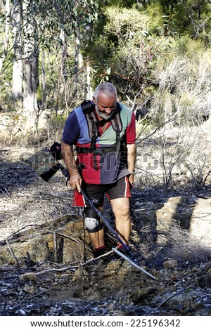 AUSTRALIA - APRIL 23: Gold miner at work detecting gold nuggets with a metal detector, April 23, 2007