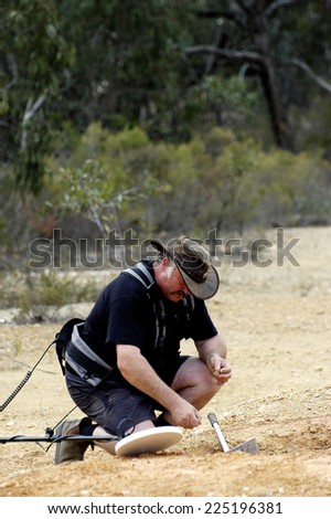 AUSTRALIA - APRIL 24: Gold miner at work detecting gold nuggets with a metal detector, April 24, 2007