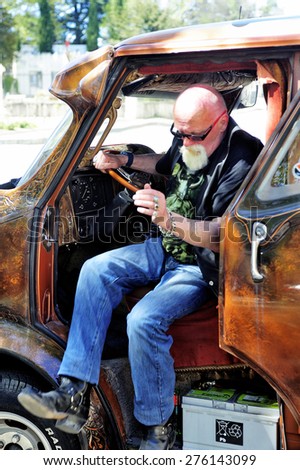 ALES, FRANCE - APRIL 11: The driver of the van Bedford 1980 painted on the theme of Leonardo da Vinci photographed at the rally of vintage cars on the Town Hall Square, April 11, 2015.