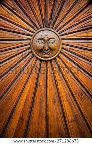 Wood door with sun symbol