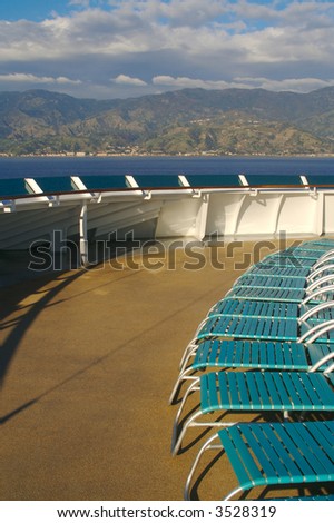 Cruise ship deck abstract shot with deck chairs. The deck is illuminated by the morning sun fresh from a wash down. Taken during a \