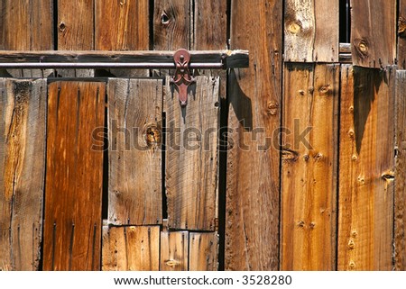 Close-up of old barn door wood and railing.
