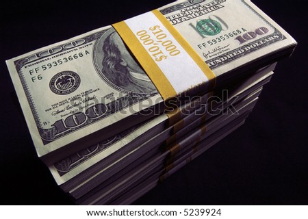 Stack of Ten Thousand Dollar Piles of One Hundred Dollar Bills on a black background.