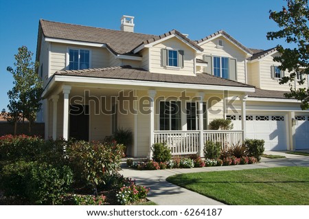 A newly constructed, modern american home with fresh landscaping - stock photo
