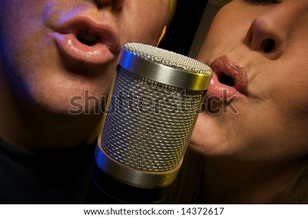 Couple Singing Duet at Condenser Microphone.