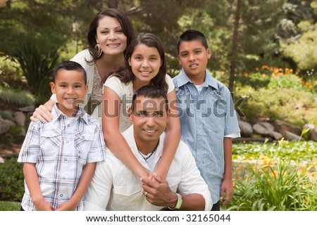 stock photo Happy Hispanic Family Portrait In the Park