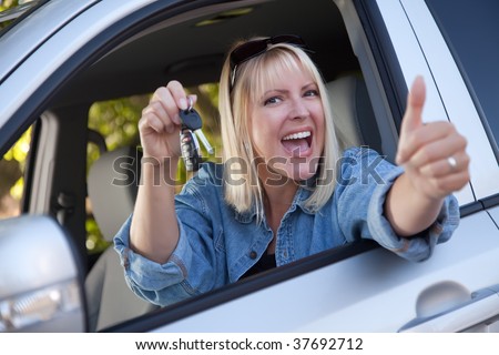 Attractive Happy Woman In New Car with Keys.