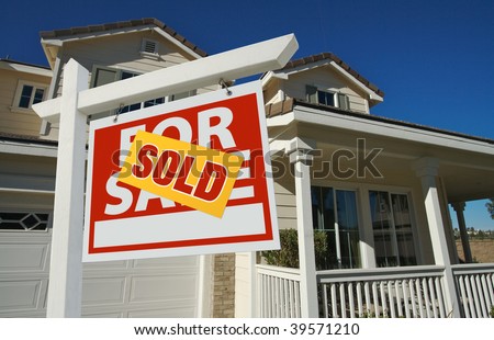 Sold Home For Sale Sign in Front of Beautiful New House.