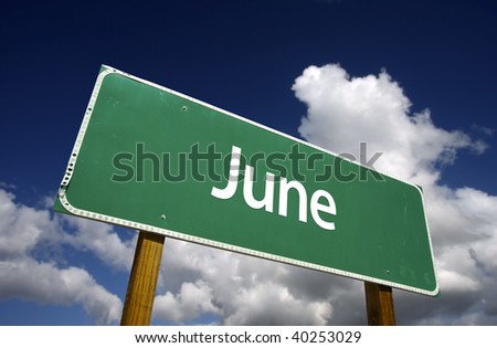 June Green Road Sign with dramatic blue sky and clouds - Months of the Year Series.