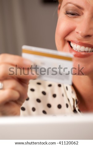 Beautiful Woman on Her Laptop Holding Her Credit Card.