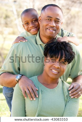 stock photo : Attractive African American Man, Woman and Child posing in the park.