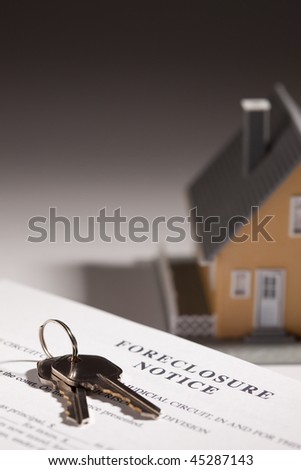 Foreclosure Notice, House Keys and Model Home on Gradated Background with Selective Focus.