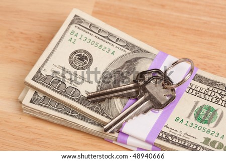 House Keys on Stack of Money - Cash for Keys Program.