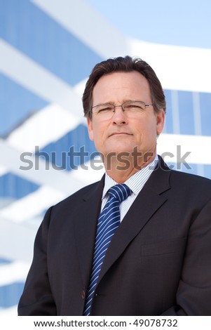 Handsome, Confident Businessman Outside of Corporate Building in Suit and Tie.