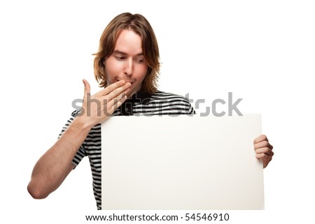 Fun Young Man with Hand Over Mouth Holding Blank White Sign Isolated on a White Background.