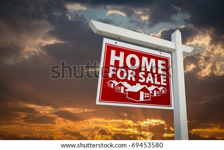 Red Home For Sale Real Estate Sign Over Beautiful Clouds and Sunset Sky.