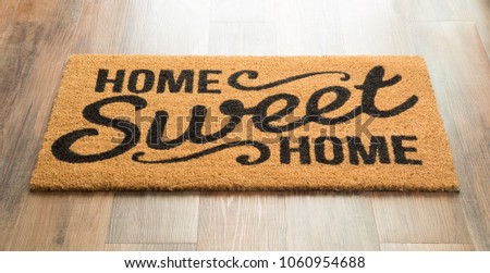 Home Sweet Home Welcome Mat On Wood Floor.