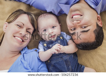 Mixed Race Family Playing Face Up on the Blanket.