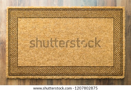Blank Welcome Mat On Wood Floor Background Ready For Your Own Text.