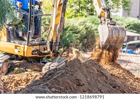 Working Excavator Tractor Digging A Trench At Construction Site.