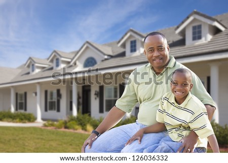 Playful African American Father and Son In Front Yard of Home.