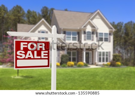 Home For Sale Real Estate Sign and Beautiful New House.
