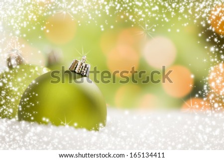 Beautiful Matt Green Christmas Ornaments on Snow Flakes Over an Abstract Snow and Light Background with Room For Your Own Text.