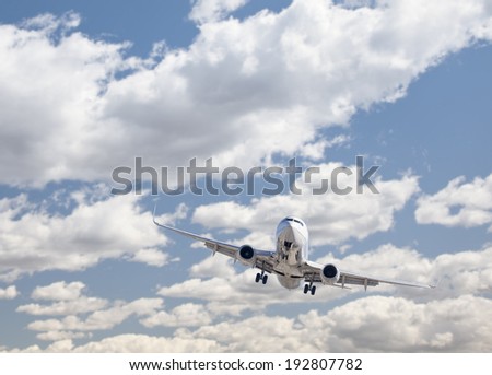 Jet Airplane Landing with Dramatic Clouds and Sky Behind.