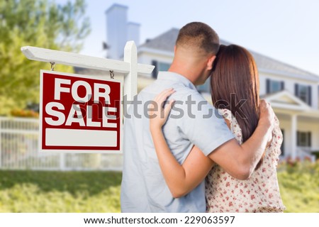 For Sale Real Estate Sign and Affectionate Military Couple Looking at Nice New House.