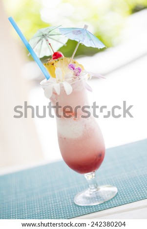 Fruity Tropical Drink with Pineapple and Umbrellas at the Bar.
