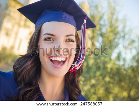 Happy Graduating Mixed Race Woman In Cap and Gown Celebrating on Campus.