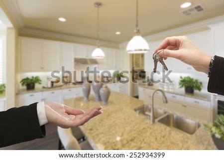 Handing Over New House Keys Inside Beautiful Custom Built Kitchen.