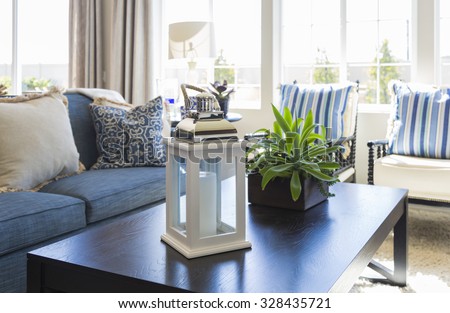 Beautiful Blue Accented Living Area with Coffee Table, Couch and Chairs of Home.