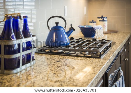Beautiful Marble Kitchen Counter and Stove With Cobalt Blue Decor.