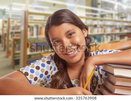 Happy Hispanic Girl Student with Pencil and Books Studying in Library.