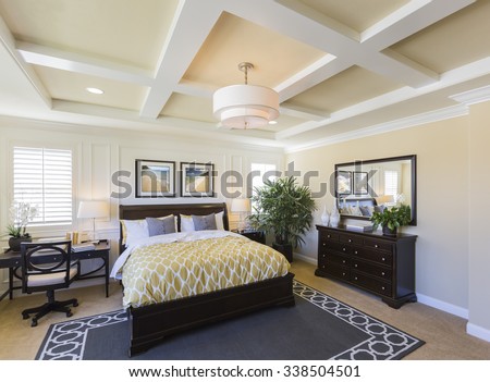 Dramatic Interior of A Beautiful Master Bedroom. The framed art is photographer\'s copyright.