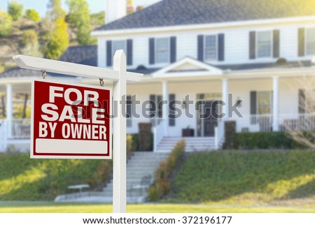 For Sale By Owner Real Estate Sign and Beautiful House.