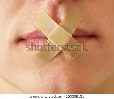 Sexy girl with an adhesive bandage her mouth.