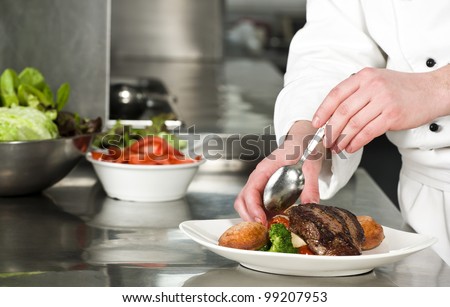Chef preparing meal (steak with croquette)